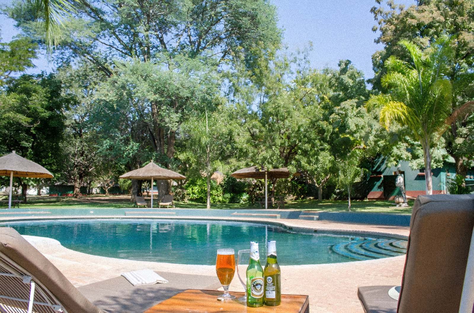 Poolside at Rest Camp with cold drinks and shaded loungers